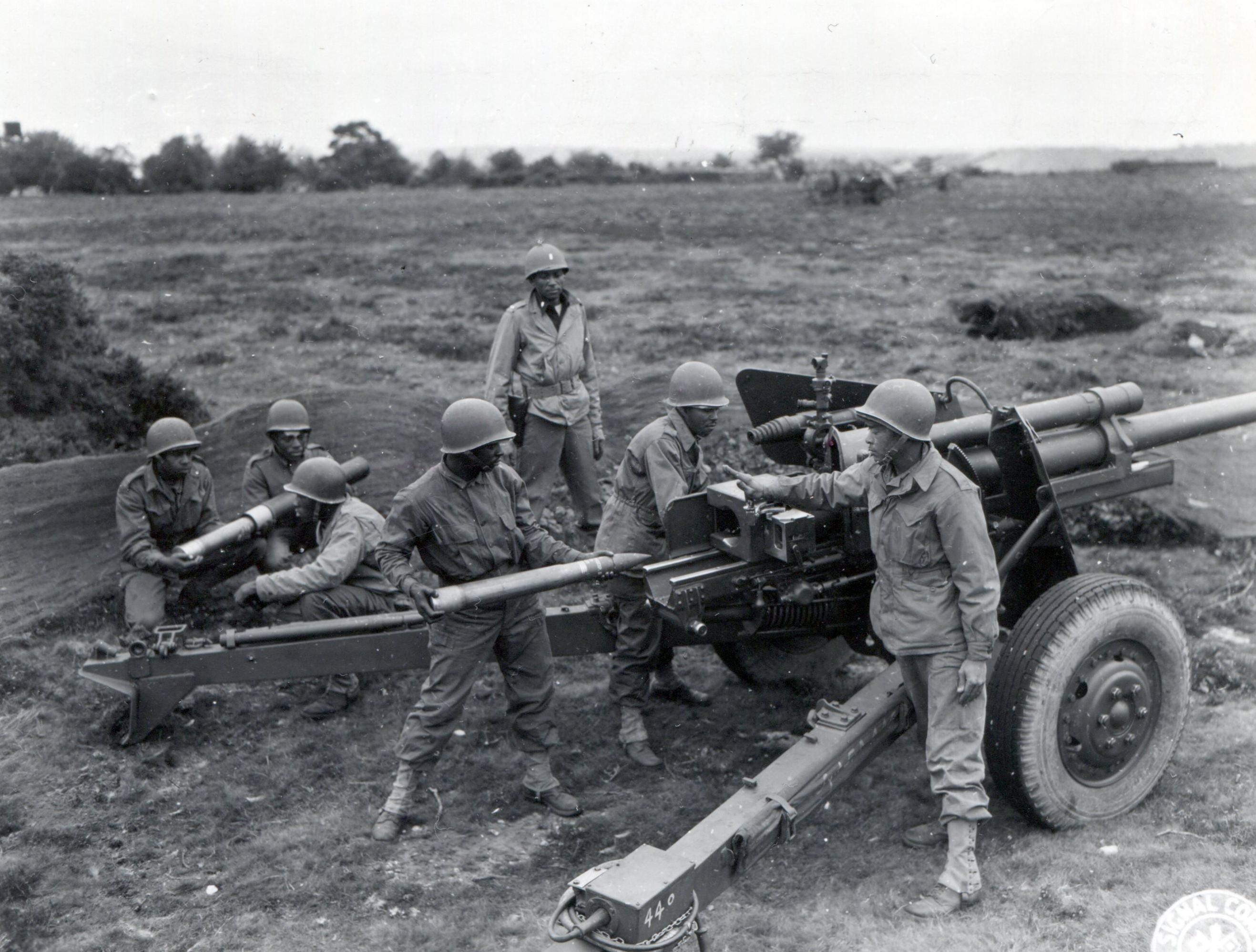 An image of a 3-inch gun of the 614th Tank Destroyer Battalion. Around it are several soldiers of the 614th TD Bn.