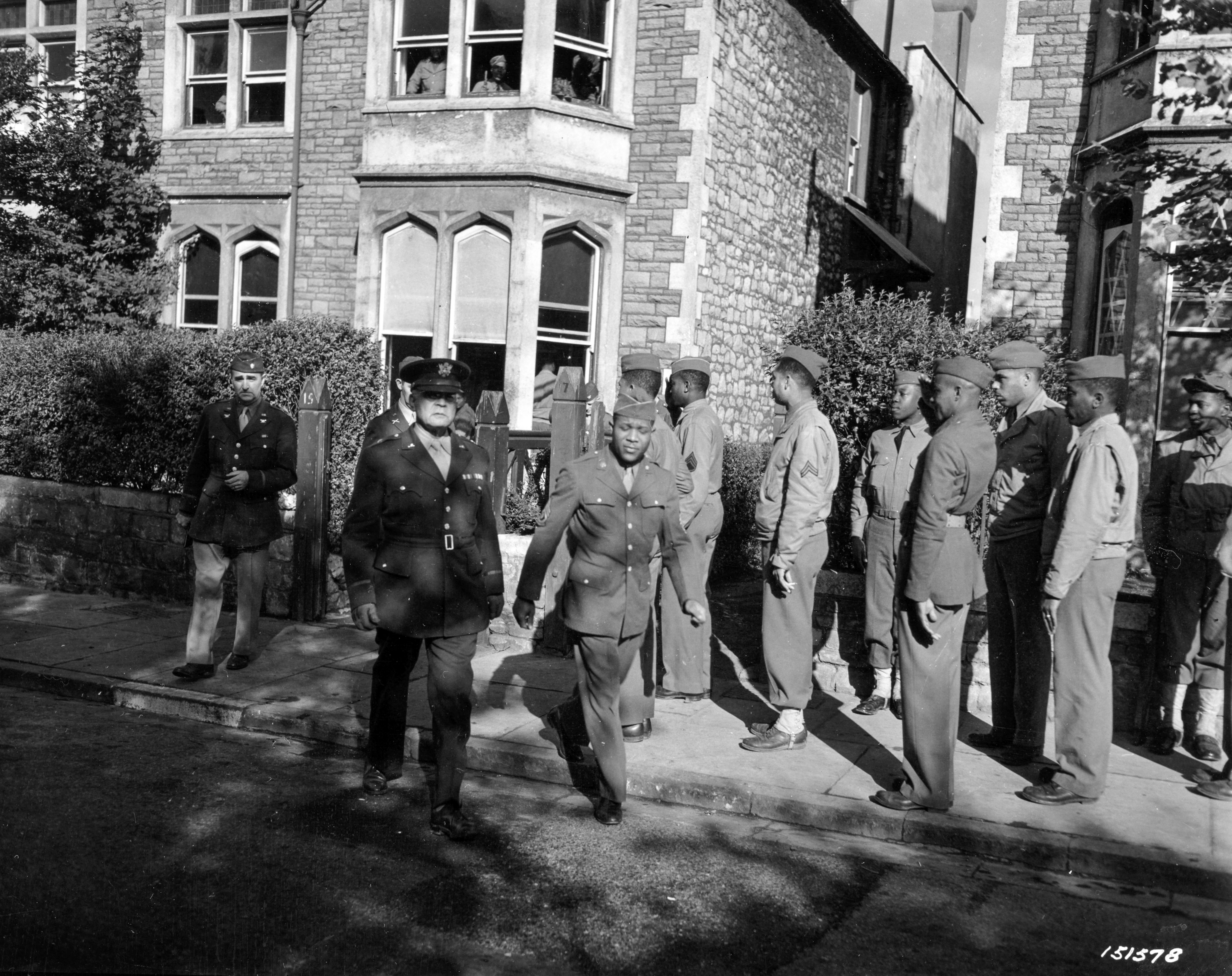 Historical image showing Brig. General Benjamin O. Davis during inspection of quarters of Black troops in England. of Black American soldiers during WWII