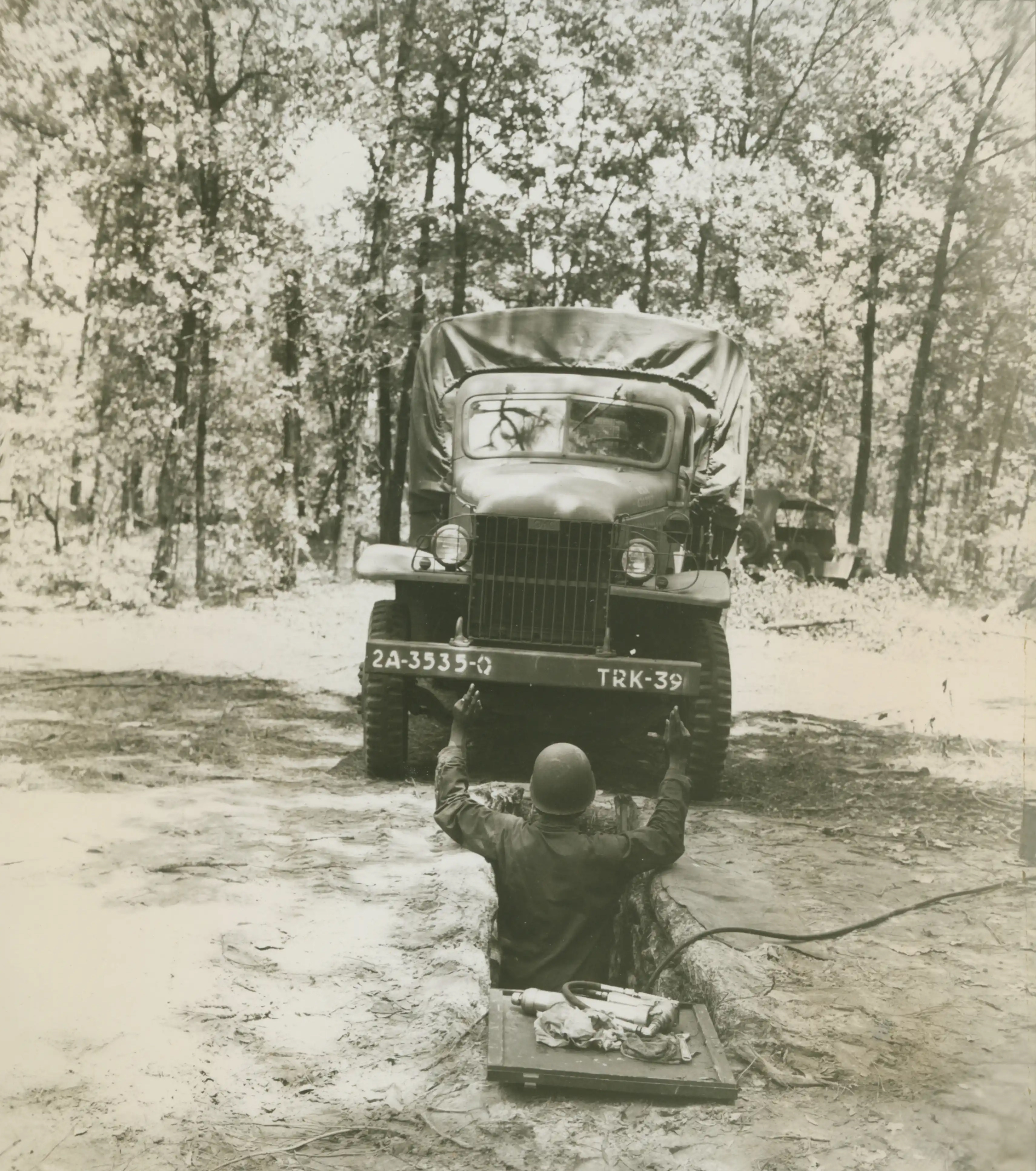 Historical image showing 3535th Quartermaster Truck Company of Black American soldiers during WWII