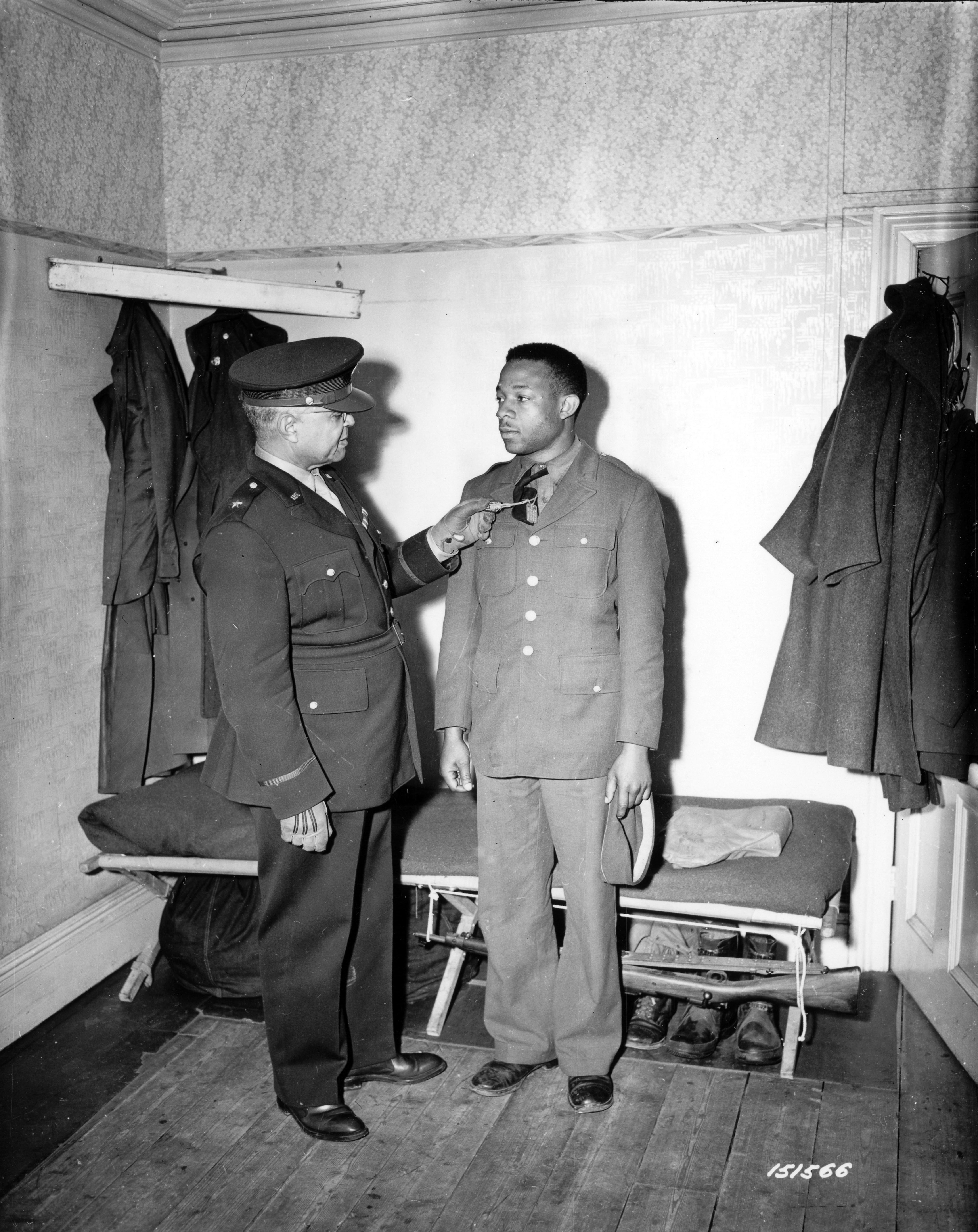 Historical image showing Brig. General Benjamin Davis is making a personnel inspection of Black troops somewhere in England. of Black American soldiers during WWII
