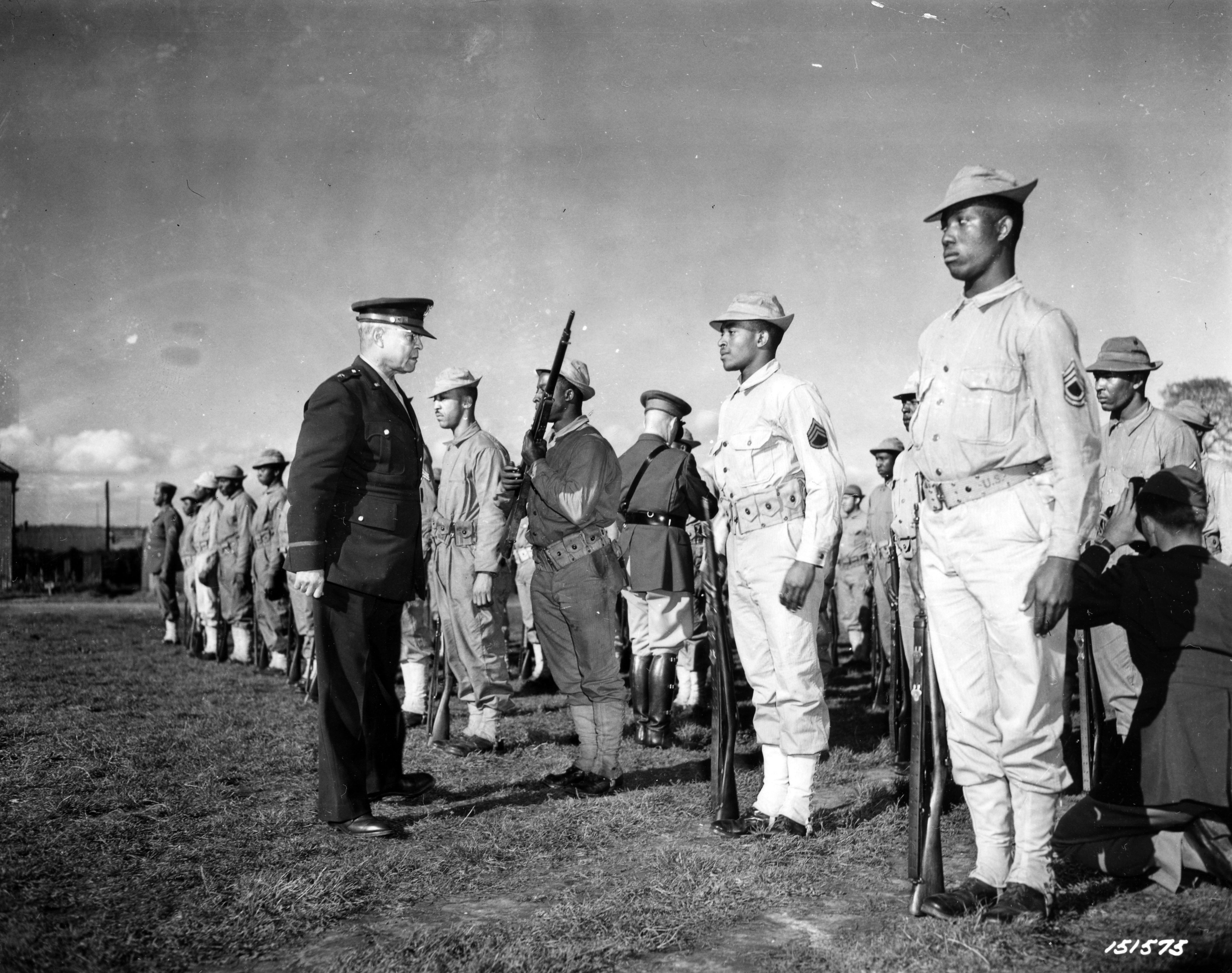 Historical image showing Brig. General Benjamin O. Davis is greatly satisfied with the skill of the individual soldier during a close inspection of Black troops in England. of Black American soldiers during WWII