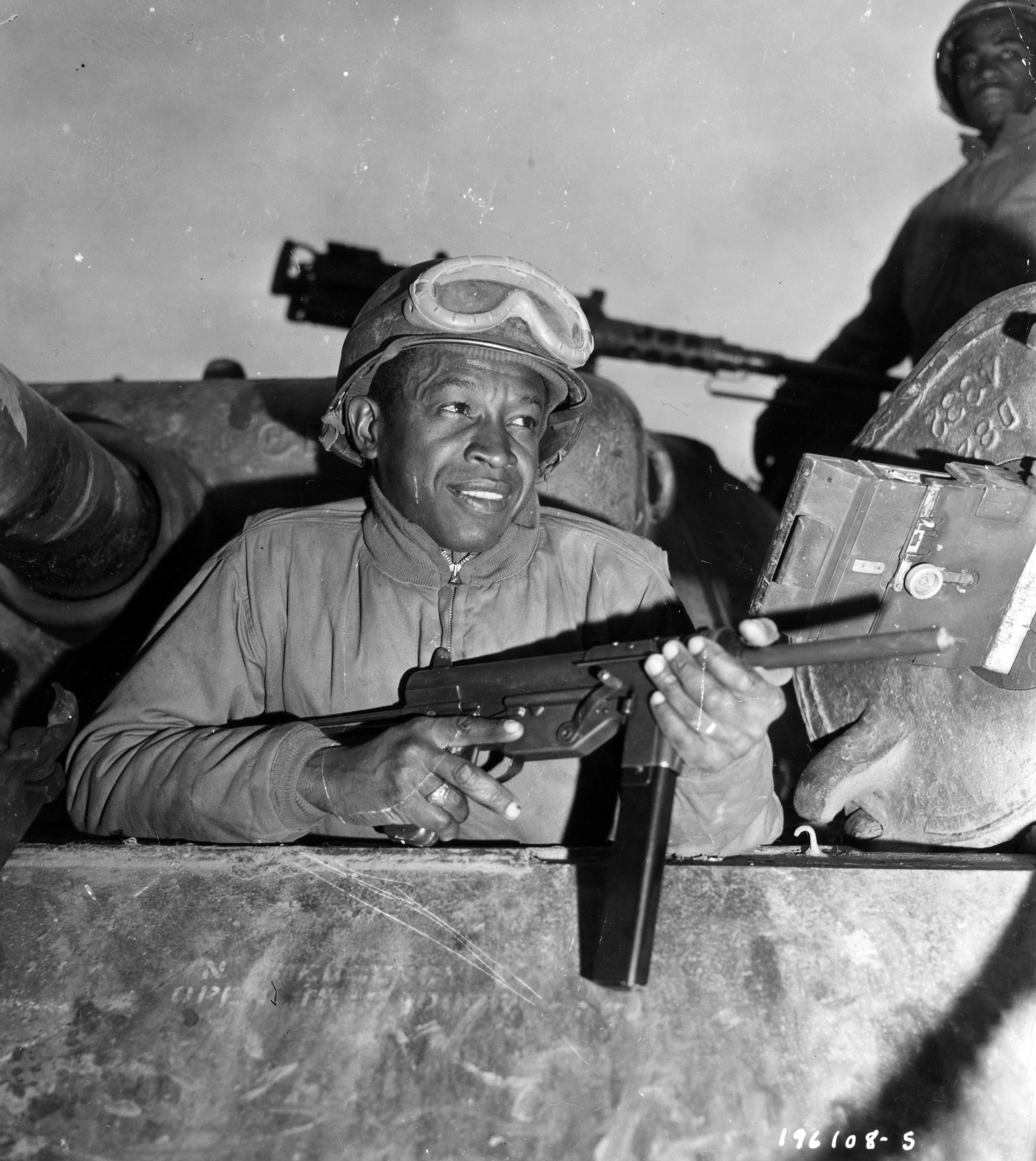Historical image showing Private L.C. Byrd, Tuscaloosa, Ala., is a commander in an M-4 tank of a Motor Transport unit near Nancy, France. of Black American soldiers during WWII