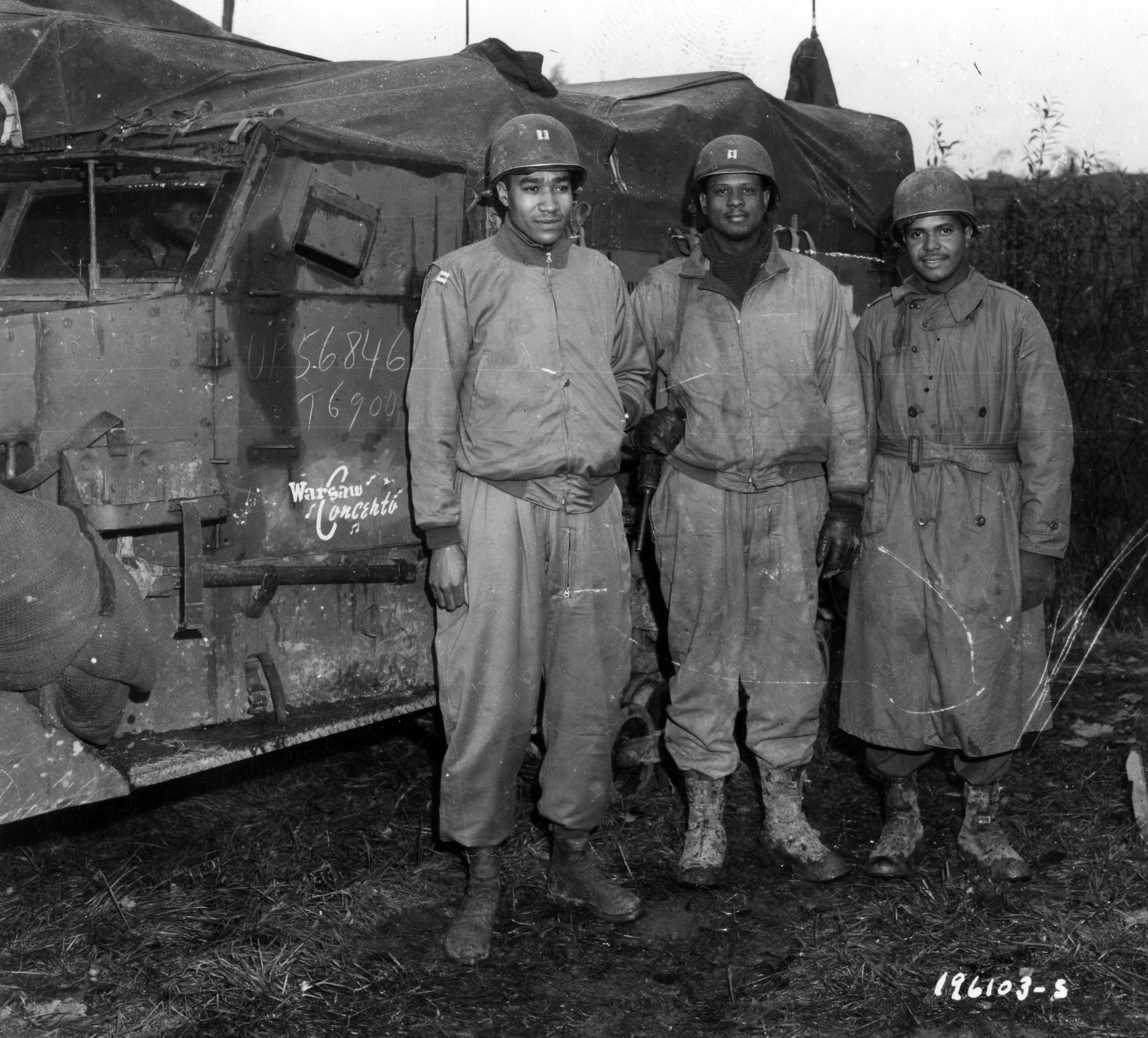 Historical image showing Field officers of a Motor Transport unit await action near Nancy, France. of Black American soldiers during WWII
