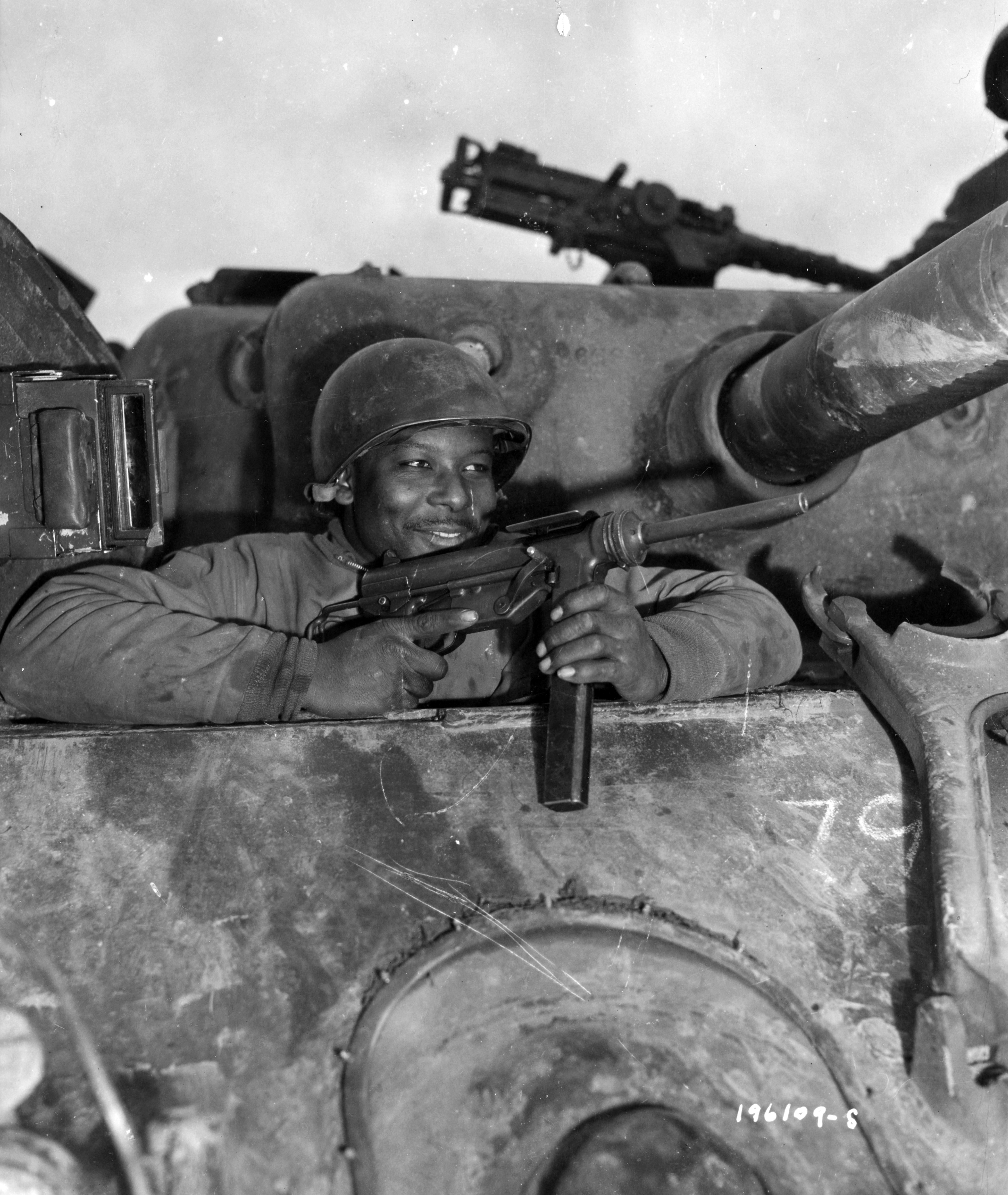 Historical image showing Private Nathaniel Simmons, Beaford, S.C., is the assistant driver of an M-4 tank, somewhere in France. Nancy. of Black American soldiers during WWII