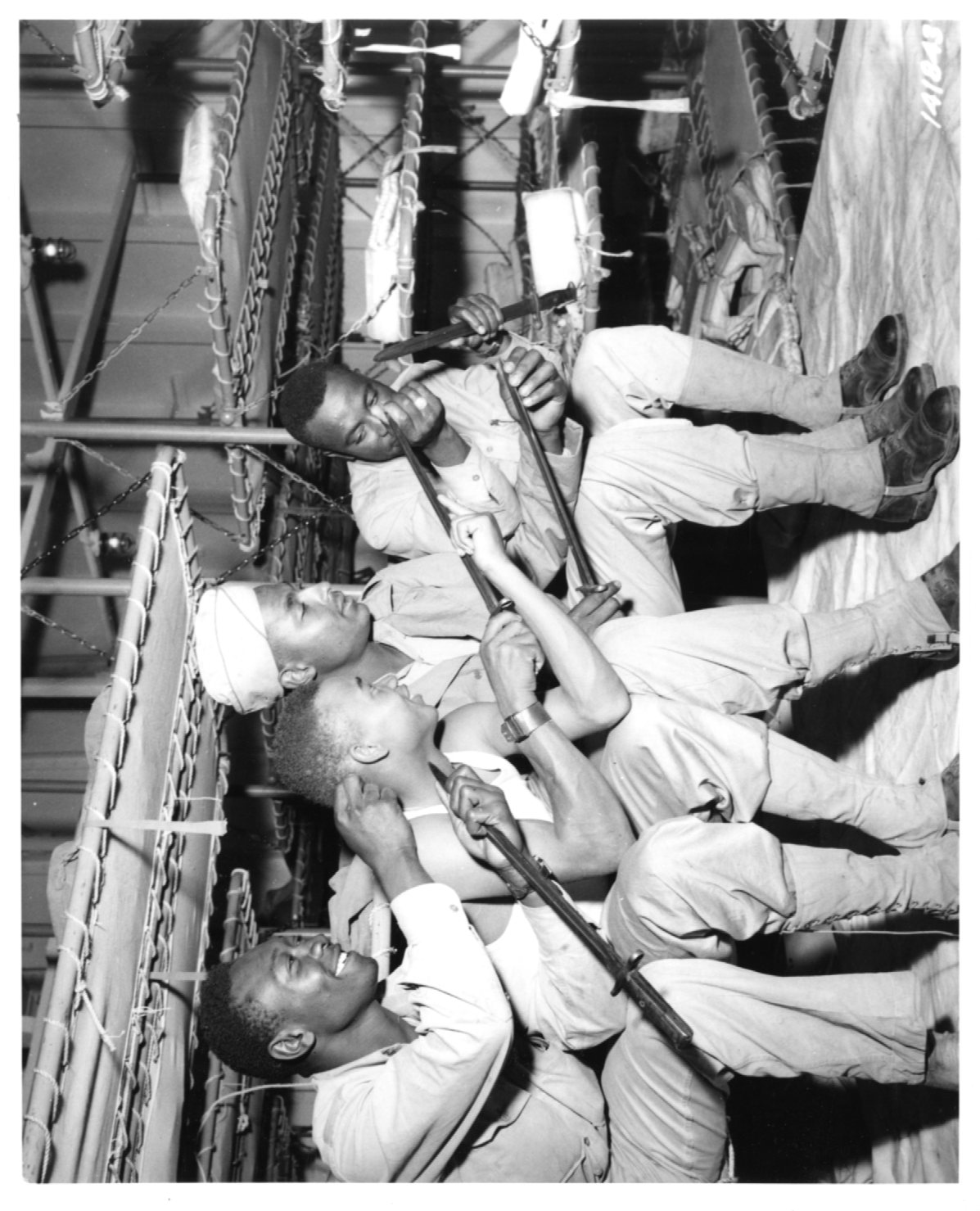 Historical image showing Soldiers of the 76th Coast Artillery Regiment show their bayonets of Black American soldiers during WWII