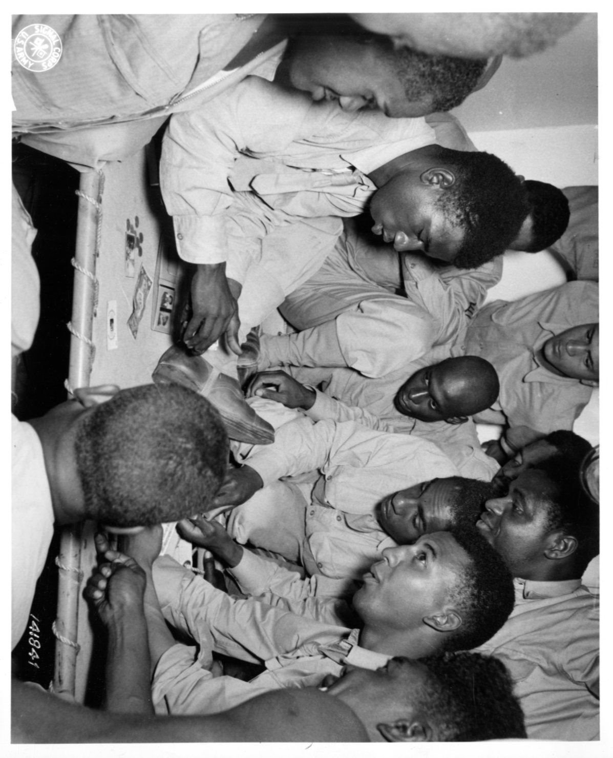 Historical image showing Soldiers of the 76th Coast Artillery are playing blackjack of Black American soldiers during WWII