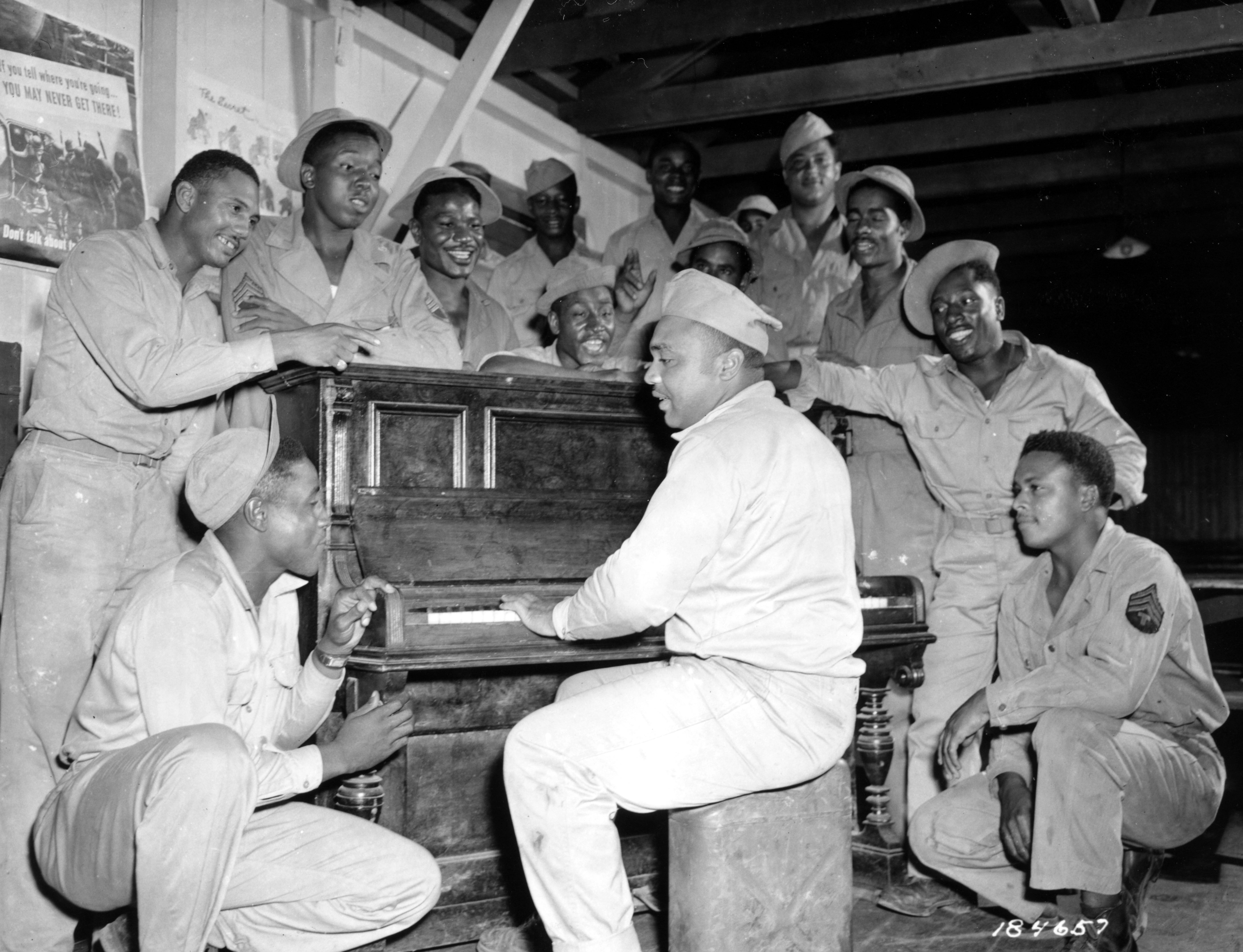 Historical image showing "Tropical Boogie-Woogie" performed by Private Albert Wright in a recreation hall in the South Pacific Area. of Black American soldiers during WWII