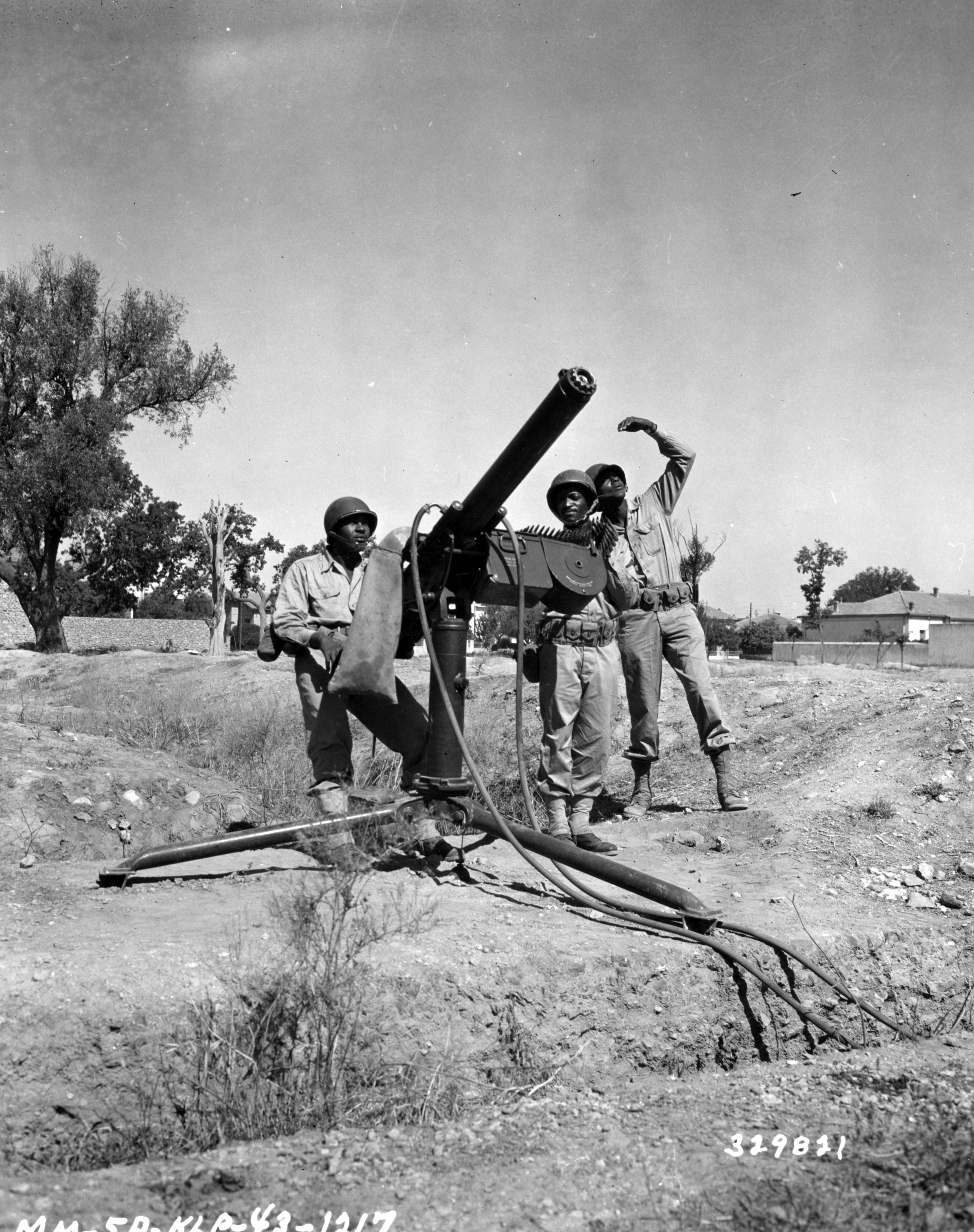Historical image showing The .50 cal. machine gun and crew of the 90th Coastal Artillery are temporarily stationed at Oujda, North Africa. of Black American soldiers during WWII