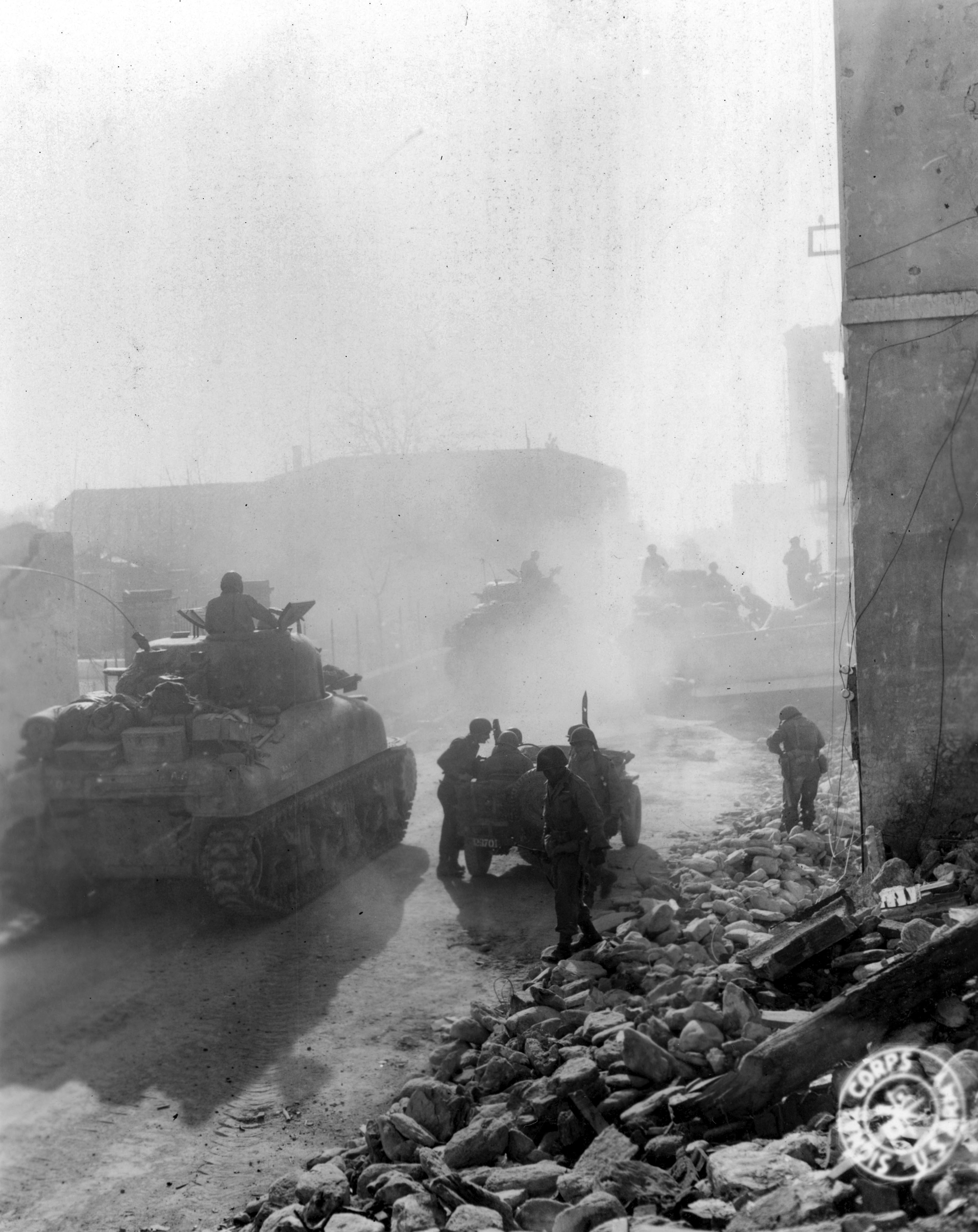 Historical image showing Querceta jammed with armor as the 92nd Division takes the offensive. of Black American soldiers during WWII