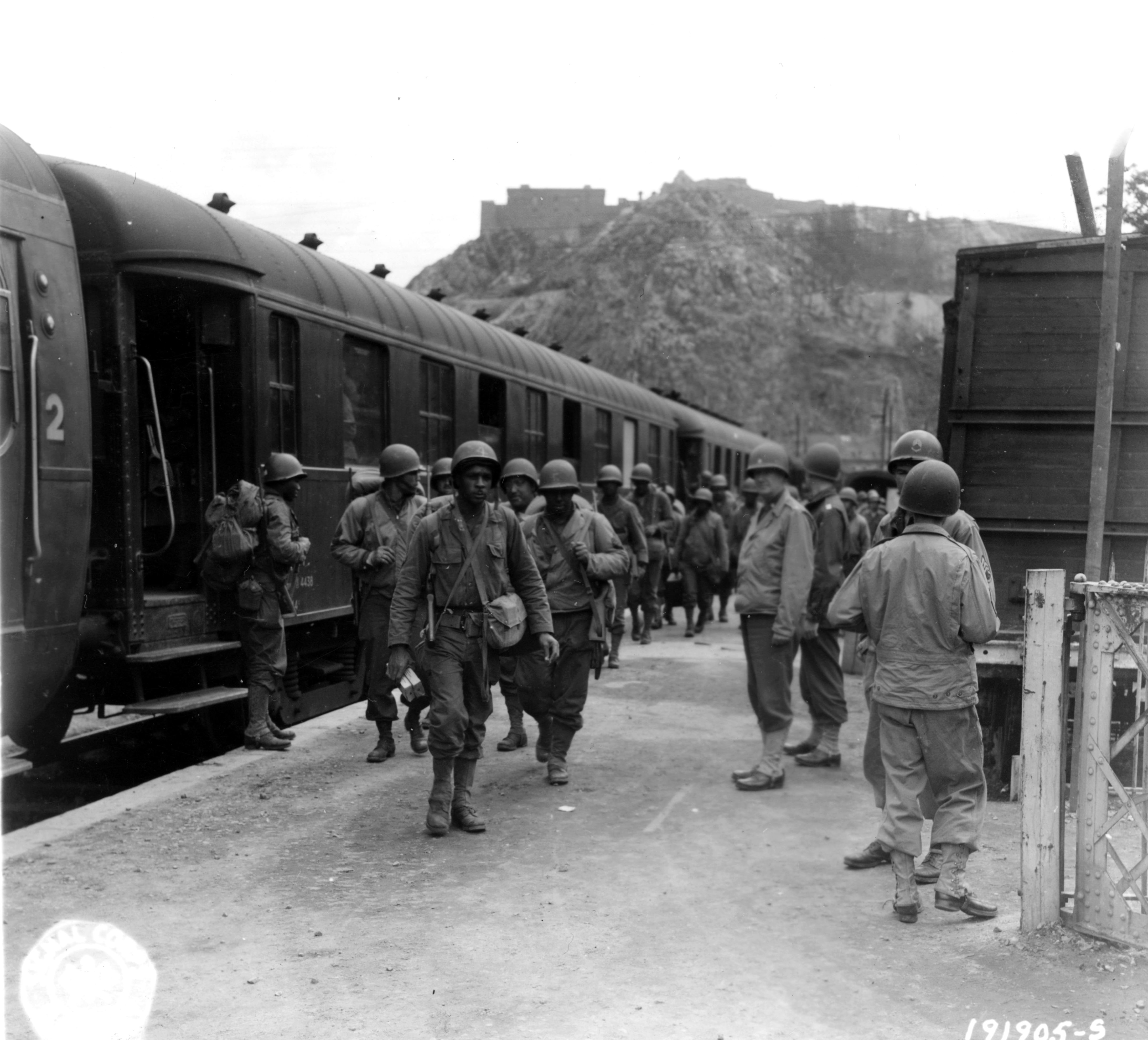 Historical image showing First Black troops arrive by train to their assigned post of duty in Cherbourg, France. of Black American soldiers during WWII
