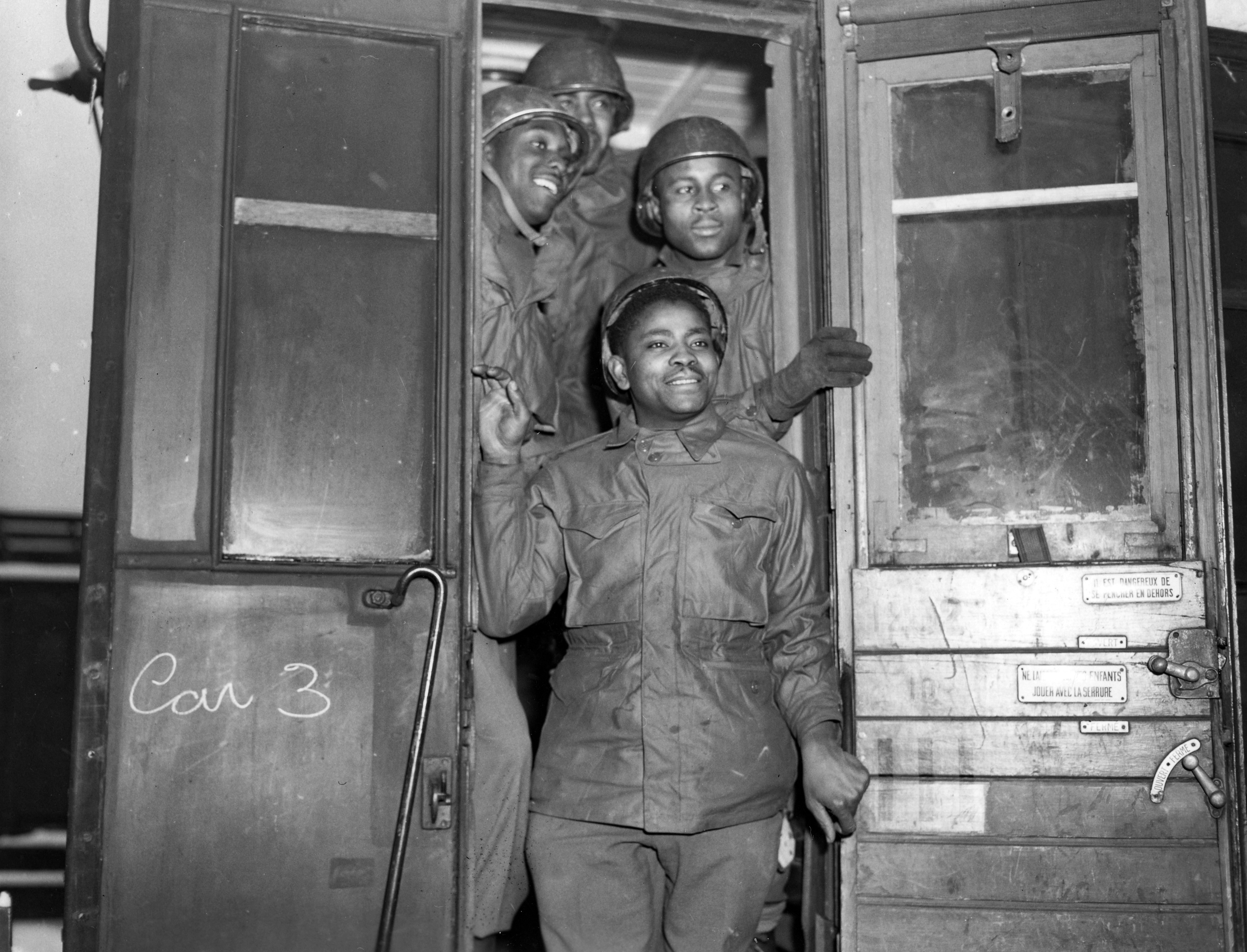 Historical image showing Four of the more than 200 service troops in France who volunteered for combat service, many of them accepting reductions in grade from Sgt. and Corporal to qualify for the new assignment. of Black American soldiers during WWII