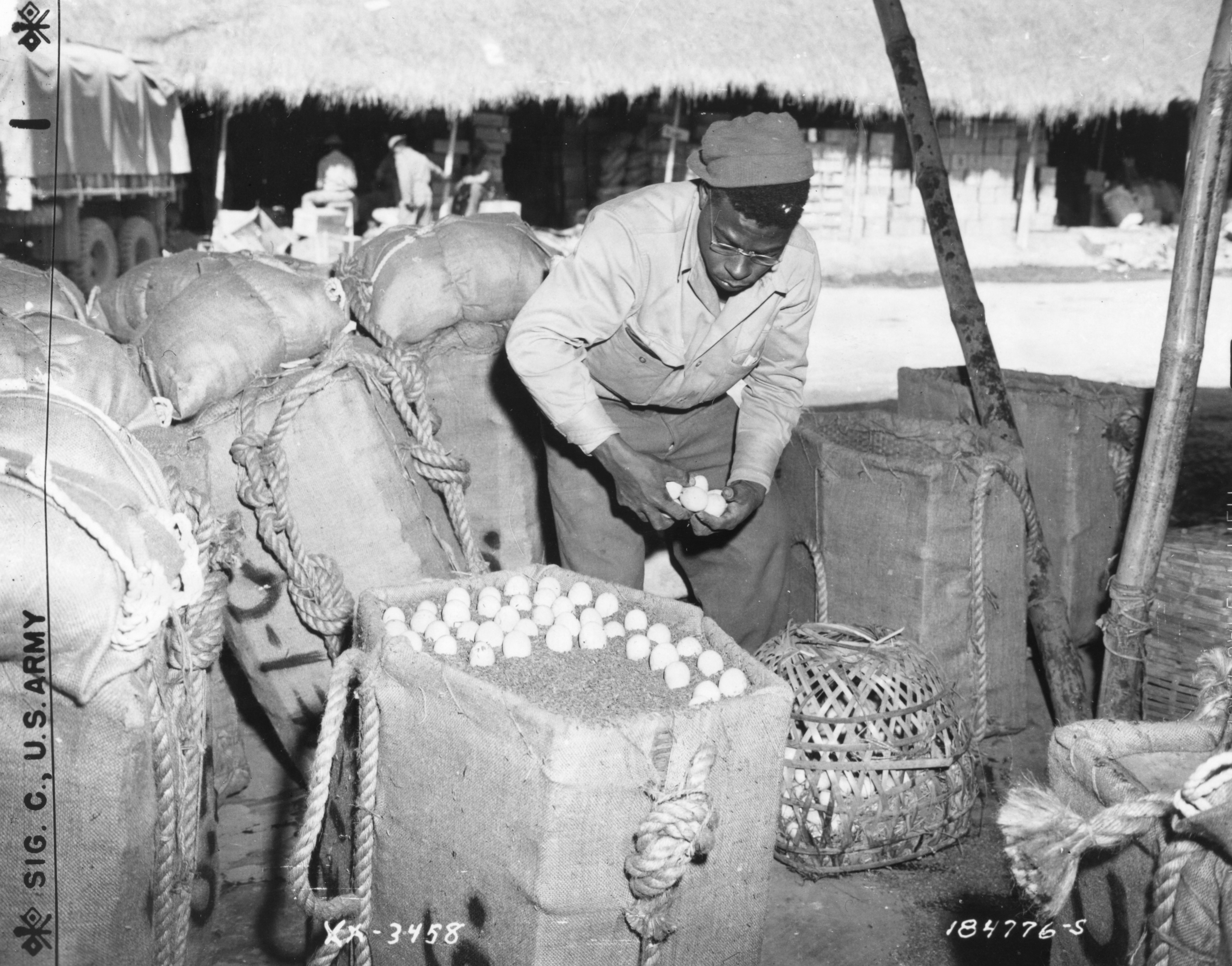 Historical image showing One of the strangest methods of merchandise delivery yet to be devised is that of parachuting eggs to earth for the use of American soldiers in the jungles of Burma. of Black American soldiers during WWII