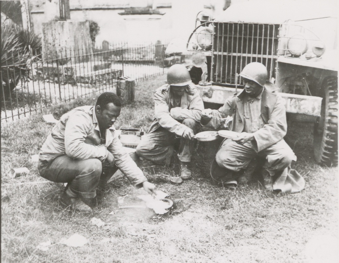 Historical image showing Red Ball Express drivers having breakfast of Black American soldiers during WWII