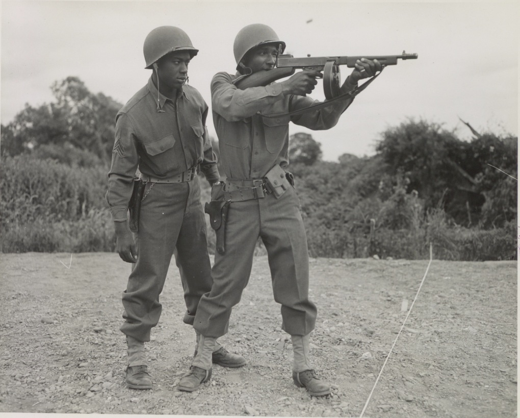Historical image showing Soldiers with a thompson machine gun. of Black American soldiers during WWII